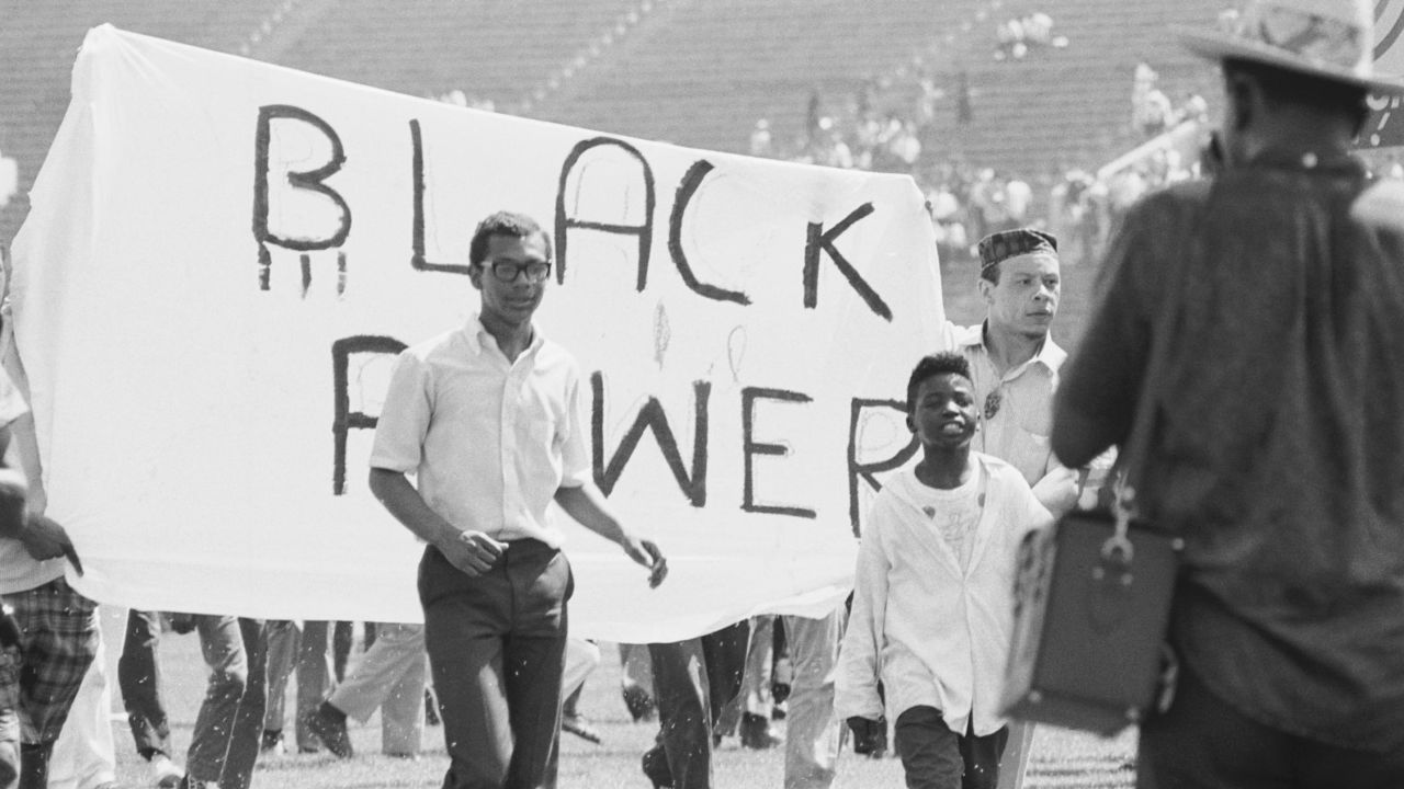 A group of teenagers carry a sign proclaiming "Black Power" during a civil rights rally in July 1966. 