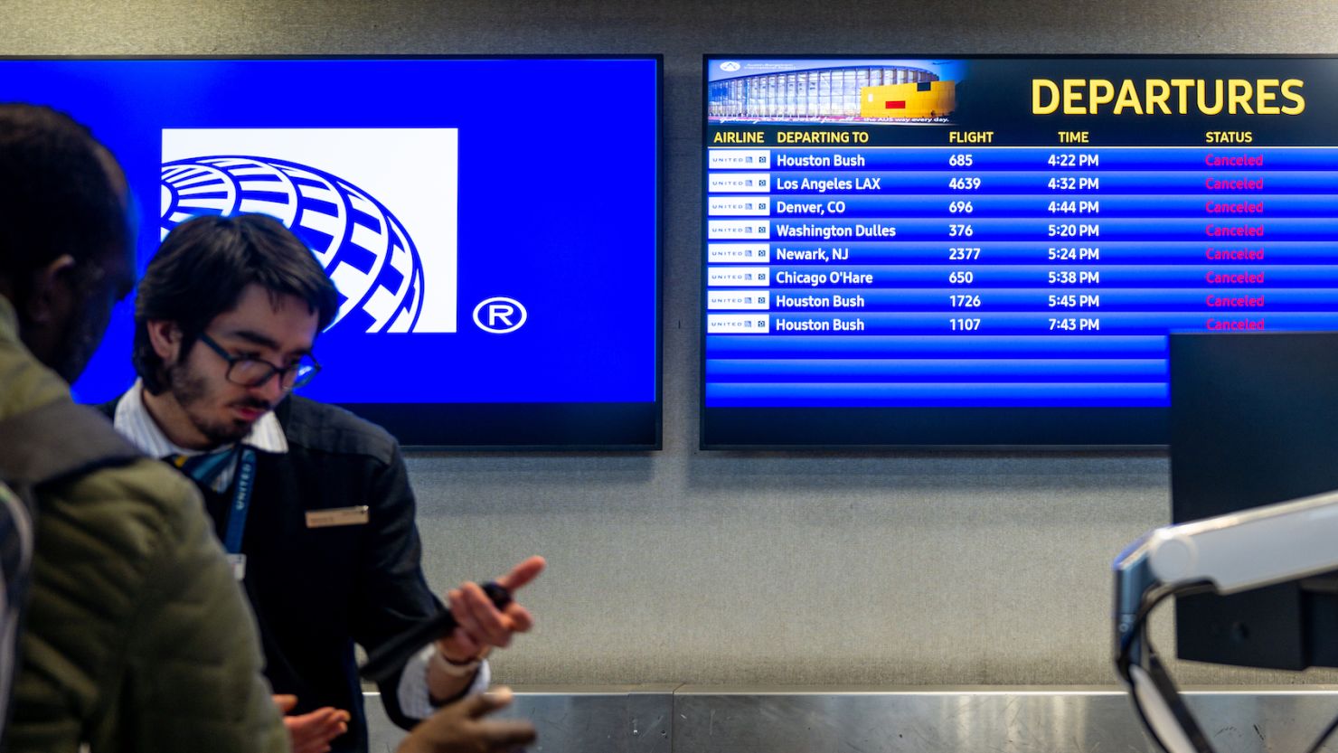 A customer speaks with a gate agent at the Austin-Bergstrom International Airport on January 31, 2023. 