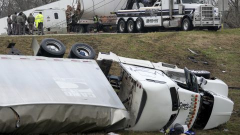 Officials investigate a crash involving 18-wheelers on a highway in the Austin, Texas, area during an ice storm on Tuesday.