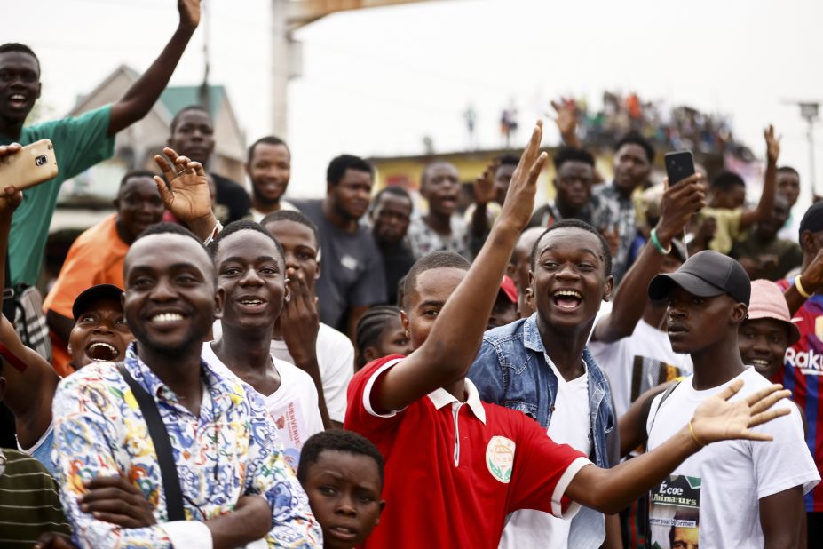 People react as Pope Francis arrives in Kinshasa on Tuesday.