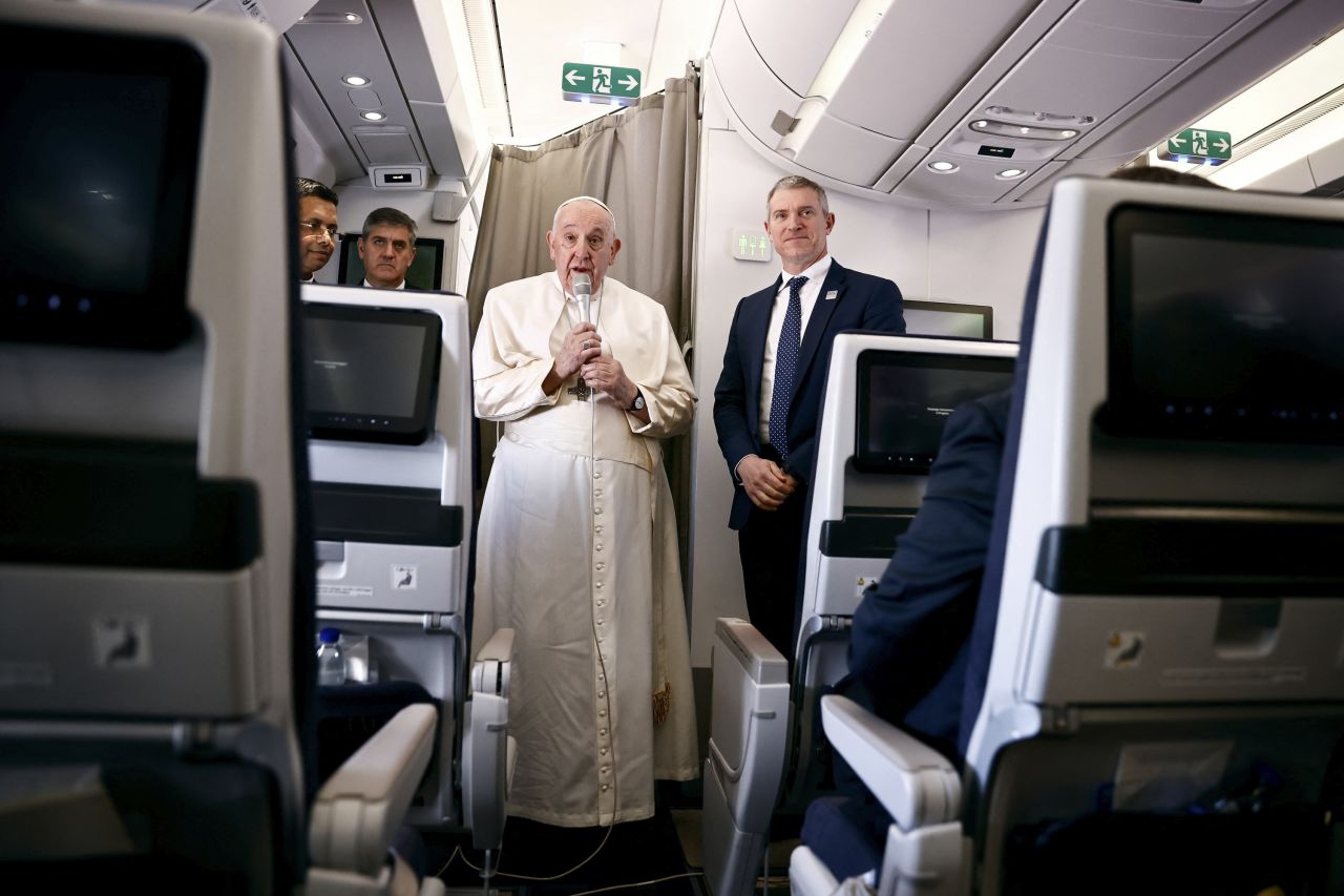 Pope Francis stands next to Vatican spokesman Matteo Bruni while aboard the plane from Rome to Kinshasa on Tuesday.