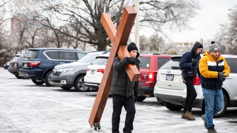 Dan Beazley, 61, left, carries wooden cross outside Mississippi Boulevard Christian Church. 