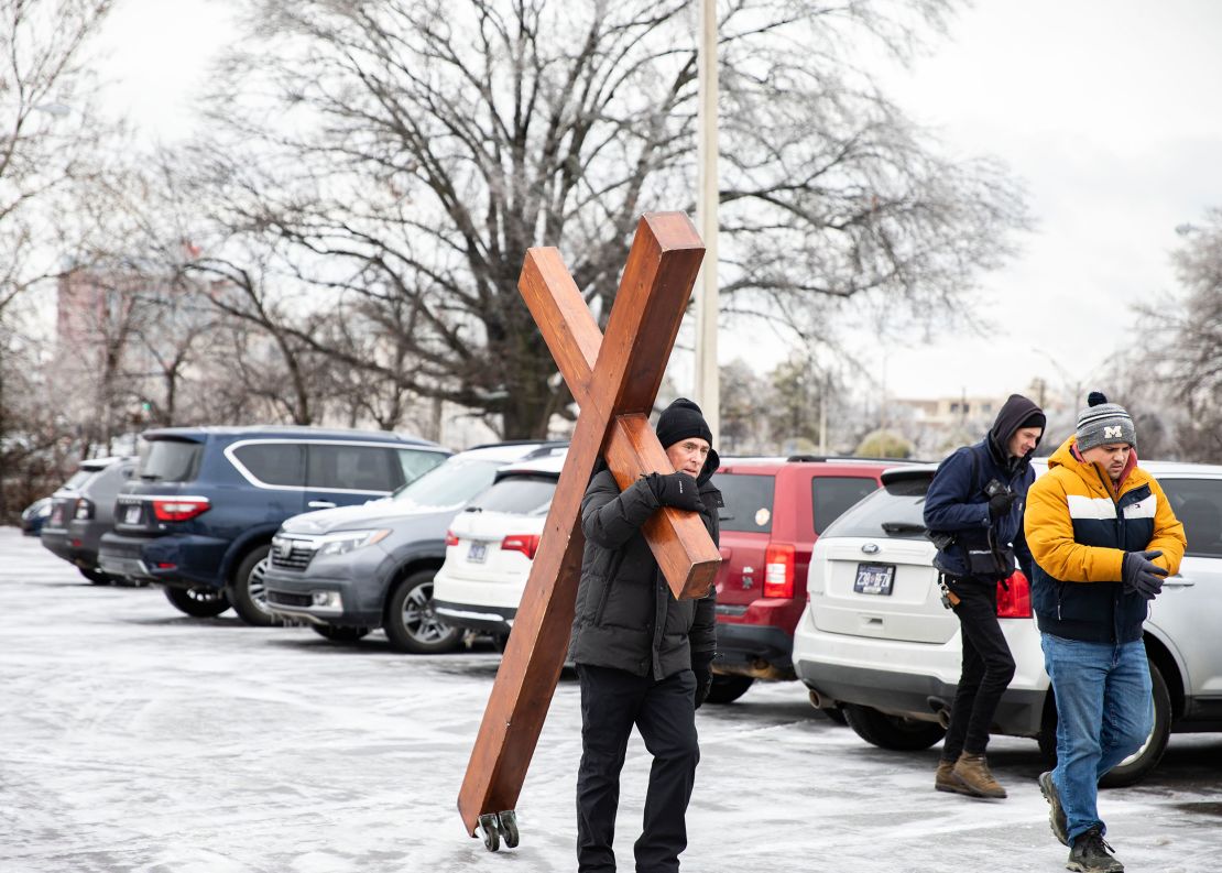 Dan Beazley, 61, left, carries wooden cross outside Mississippi Boulevard Christian Church. 