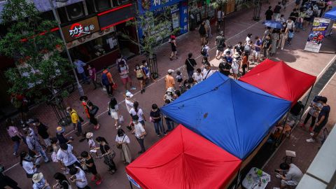People line up to cast their ballots in the unofficial primary election, organized by pro-democracy opposition parties on July 11, 2020.