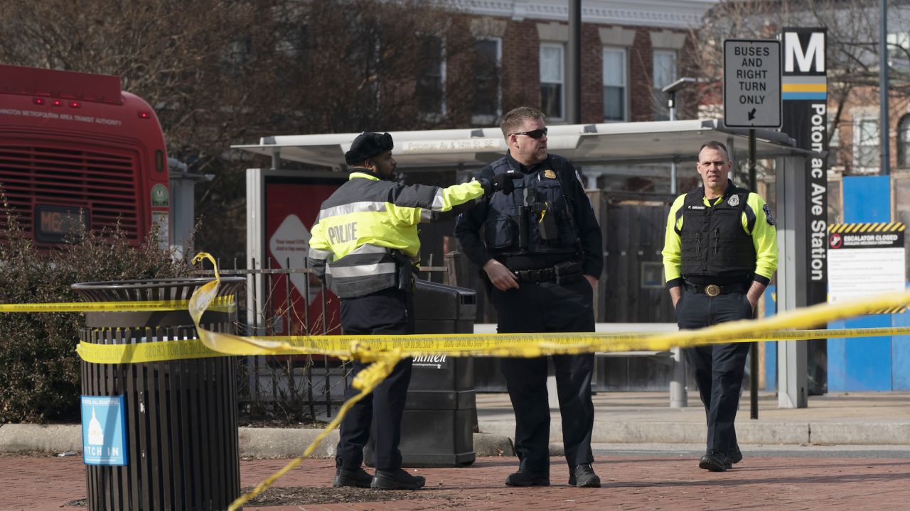 Police officers investigate a shooting at the Potomac Avenue Metro Station in southeastern Washington, DC, on Wednesday.