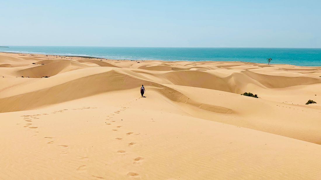 <strong>Golden sand:</strong> Nina walking along the sand dunes during their time in Iran.