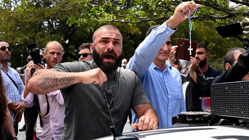 NextImg:Former Australian PM hails George Pell as a 'saint' as funeral of controversial cardinal sparks protests | CNN