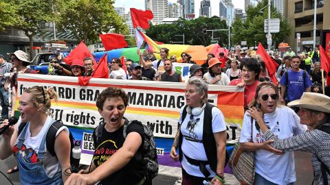 Protesters march through Sydney on Thursday with flags and banners.