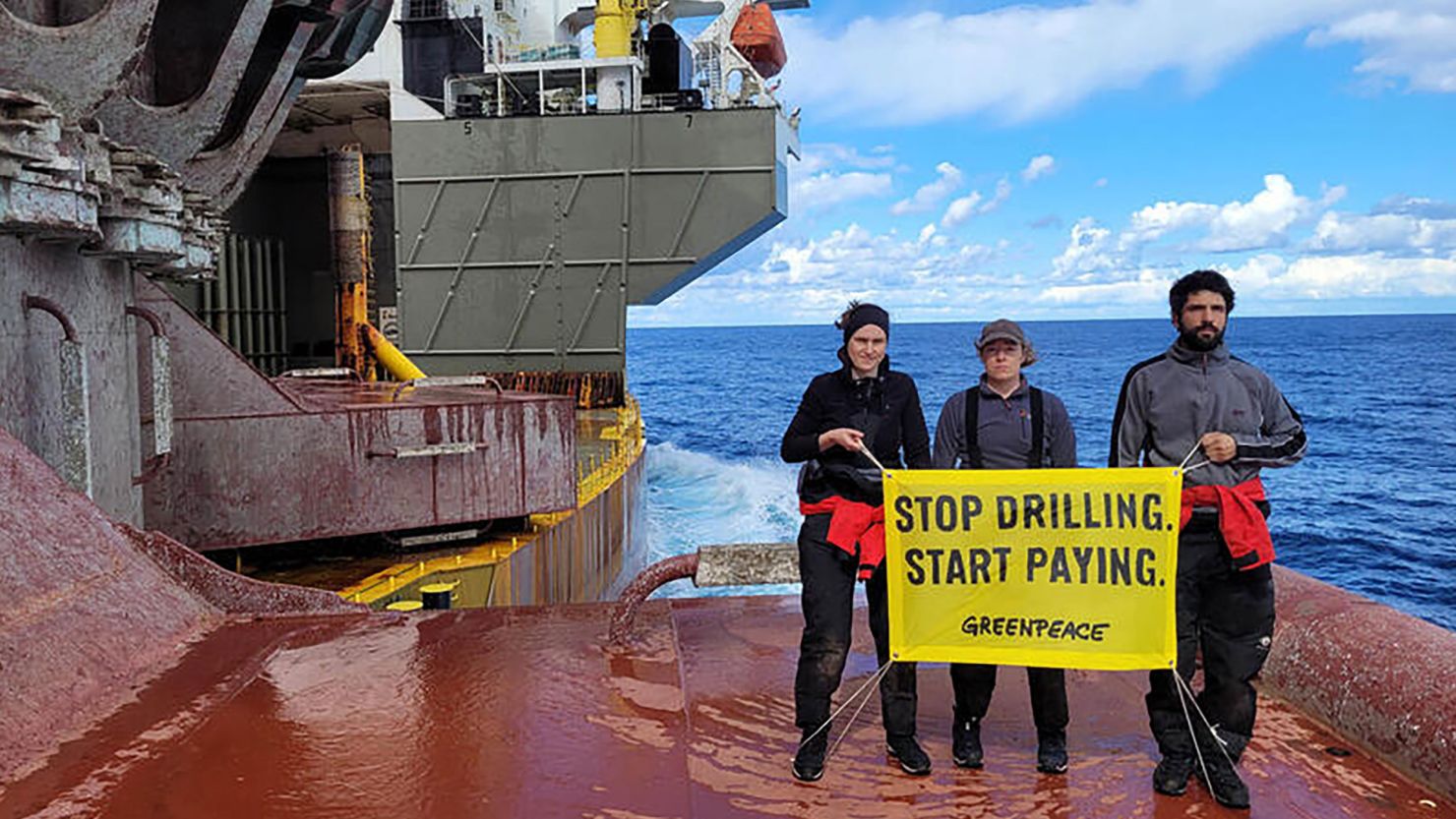 Greenpeace climate activists on board Shell's oil platform en route to a major oil field with message: 'Stop Drilling. Start Paying.'  