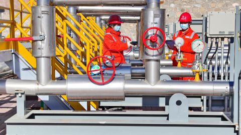 Technicians inspect a natural gas pipeline connected to Russia at a gas-distributing station in northern China's Hebei province in November 2022.