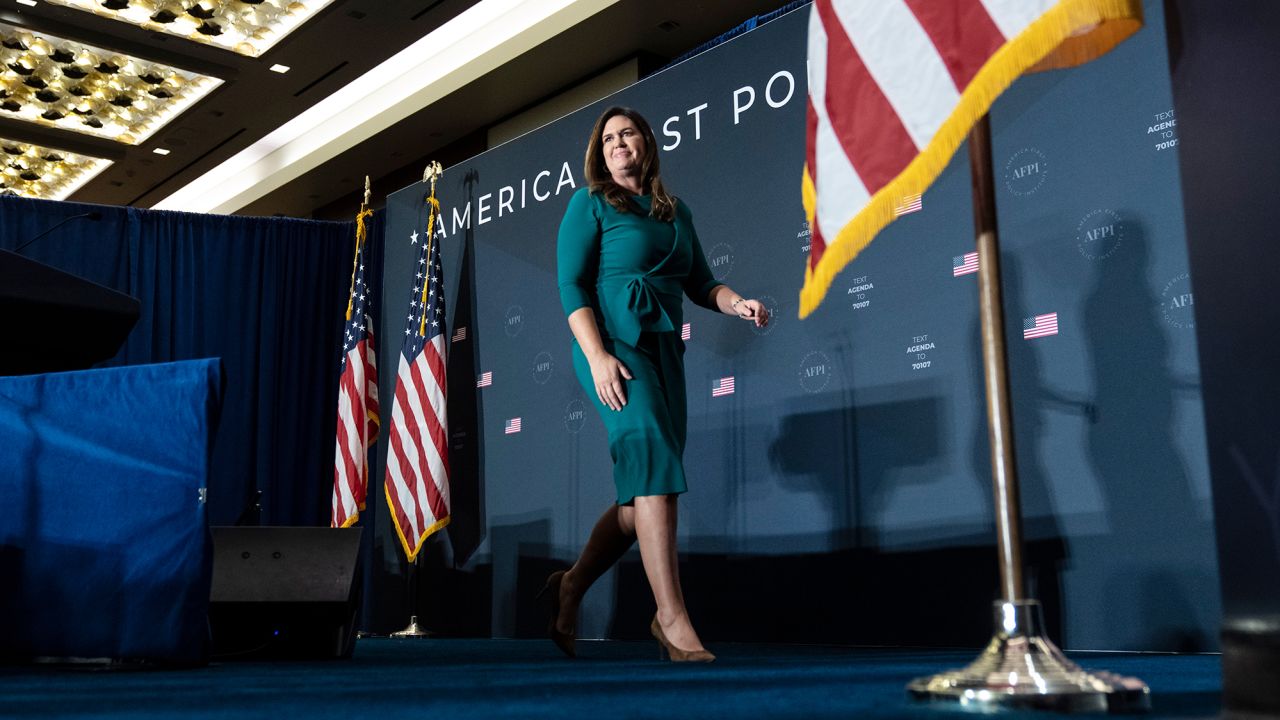 Sarah Huckabee Sanders departs the stage after speaking at the America First Agenda Summit in Washington, DC, on July 26, 2022.