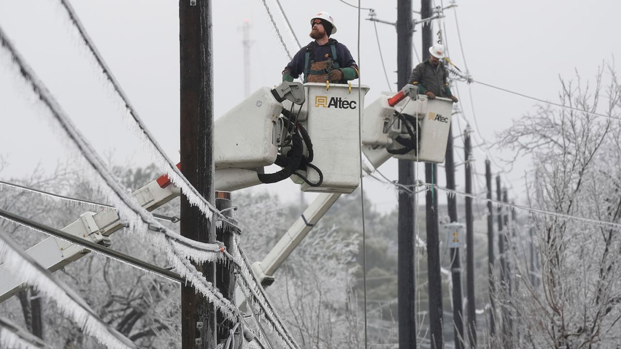 Austin Energy linemen work to restore power on ice-covered lines Wednesday in Austin, Texas. 