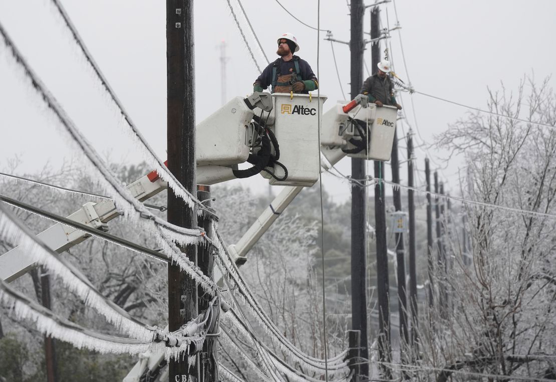 Austin Energy linemen work to restore power on ice-covered lines Wednesday in Austin, Texas. 