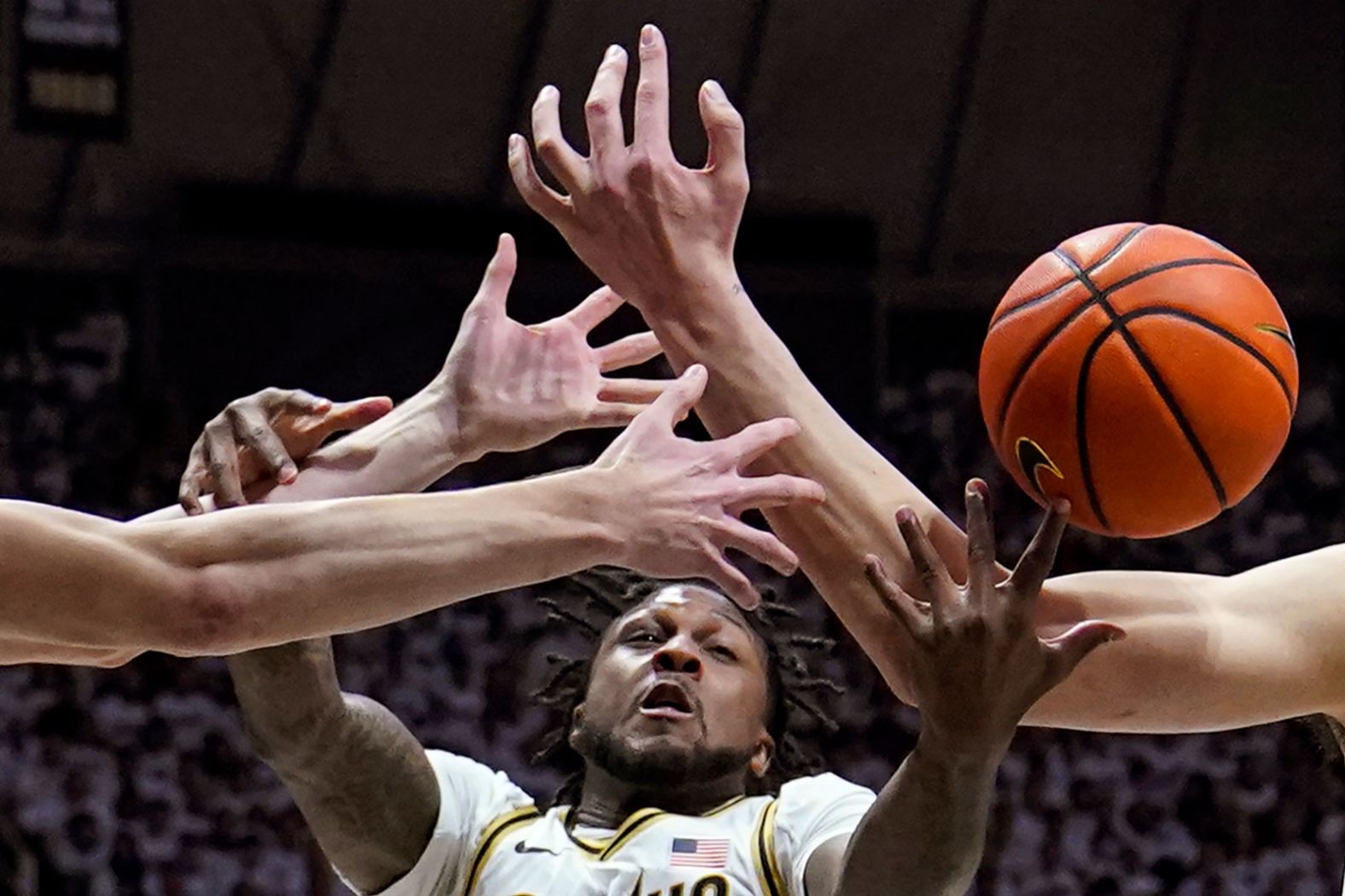 Purdue guard David Jenkins Jr. fights for a rebound with teammate Zach Edey, right, and Michigan State center Carson Cooper, left, during a college basketball game in West Lafayette, Indiana, on Sunday, January 29.