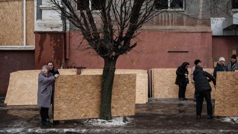 People receive plywood to cover broken windows in Kramatorsk on February 2.