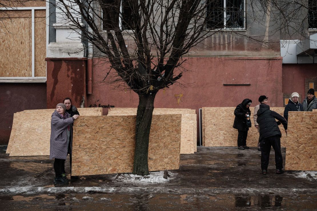 People receive plywood to cover broken windows in Kramatorsk on February 2.