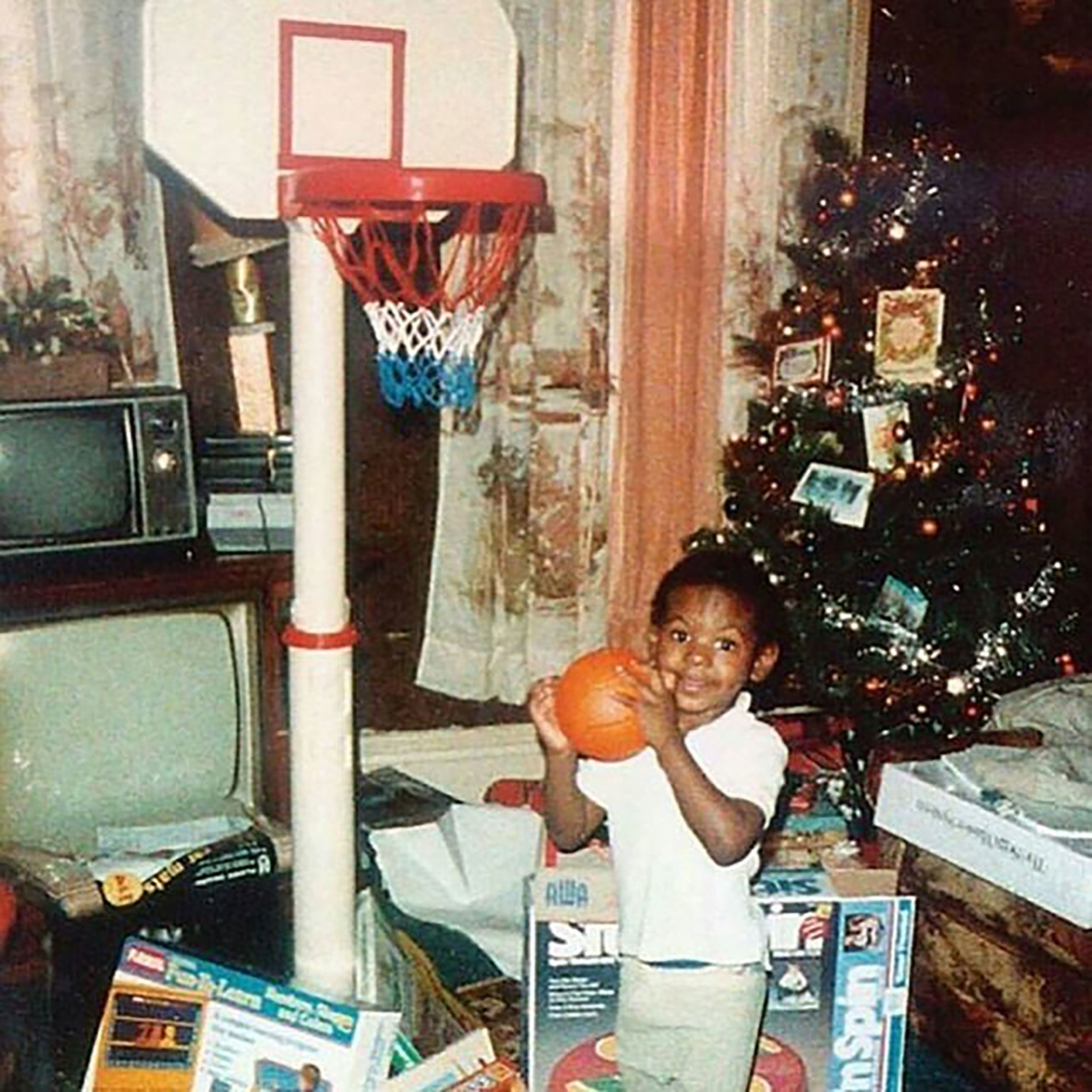 A young James plays on a toy basketball hoop at Christmas time.