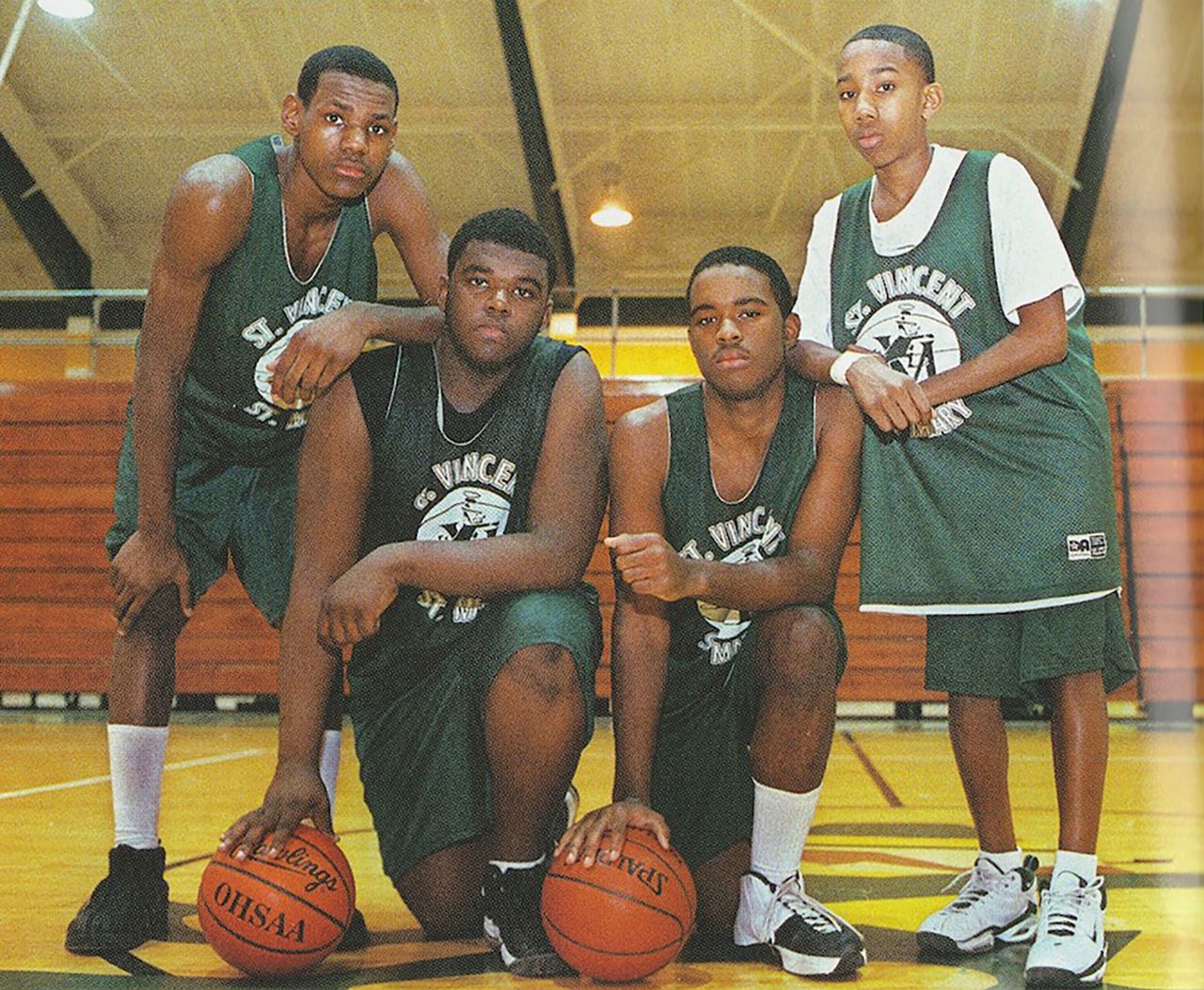 James, left, poses with some of his teammates at St. Vincent-St. Mary High School during his freshman year.
