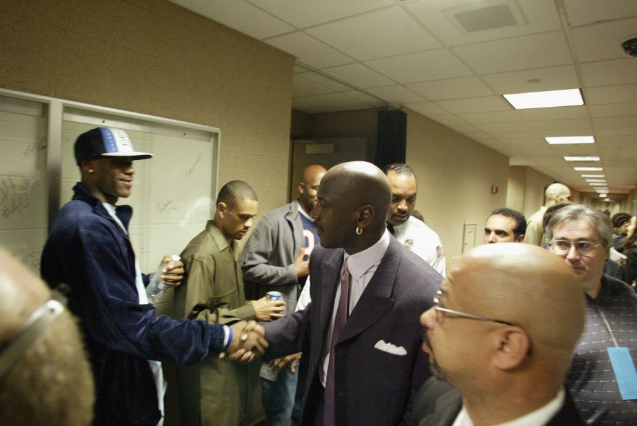 James shakes hands with NBA star Michael Jordan after Jordan played a game in Cleveland in April 2003. James chose the number 23 because of Jordan.