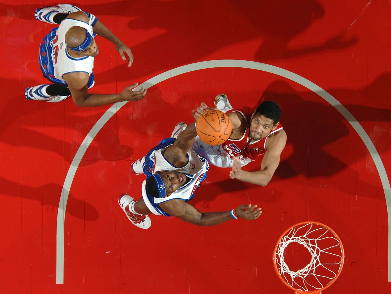 James, center, goes up for a rebound with Tim Duncan during the 2006 NBA All-Star Game. He was named the game's most valuable player — the youngest to ever receive the award.