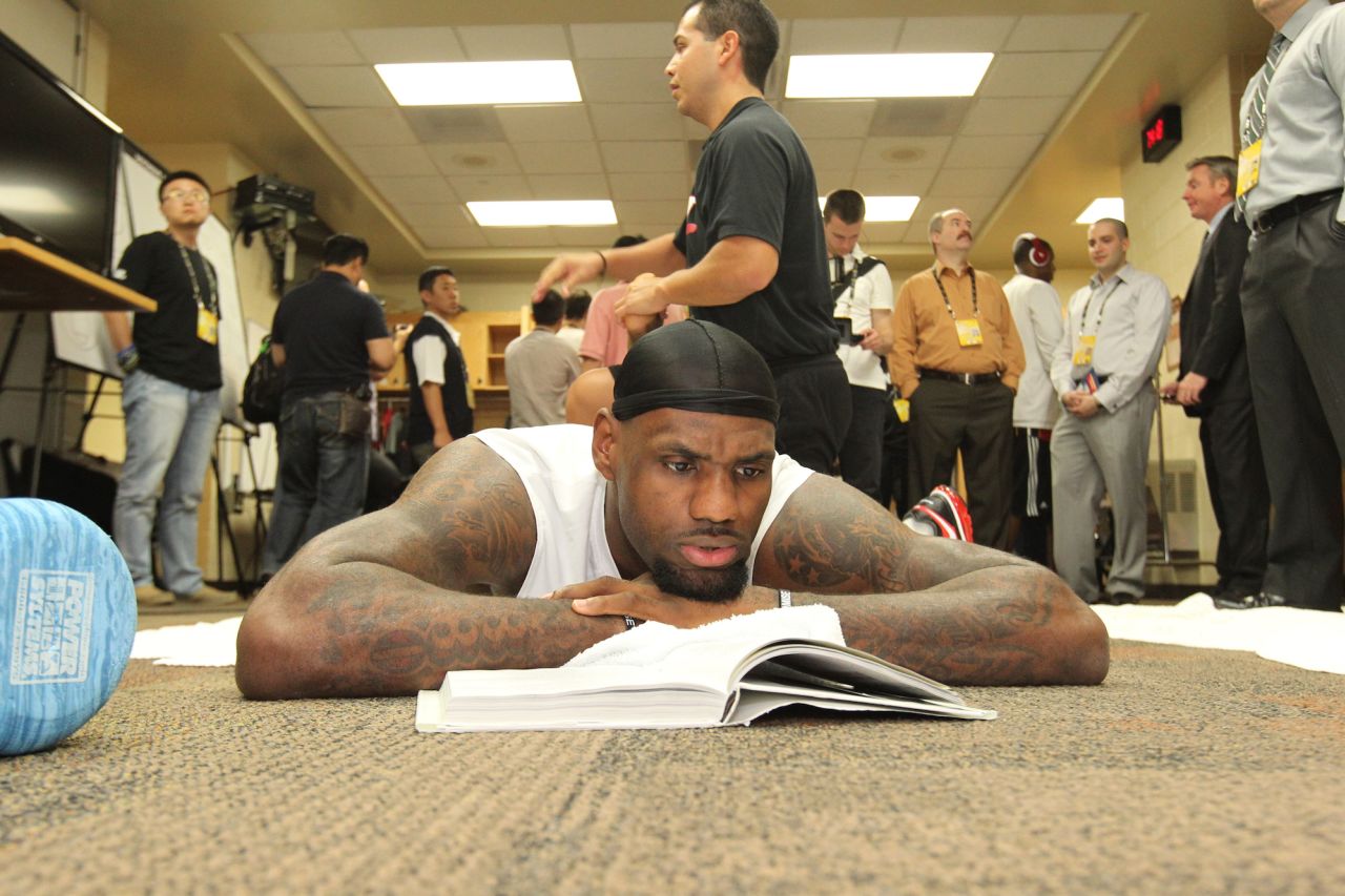 James reads in the locker room before an NBA Finals game in June 2012. The Heat were back in the Finals, this time facing the Oklahoma City Thunder.