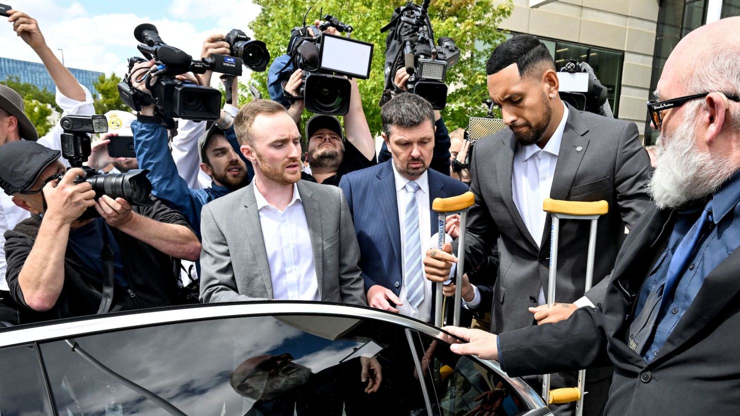 Australian tennis player Nick Kyrgios leaves the magistrate's court in crutches in Canberra on February 3, 2023.