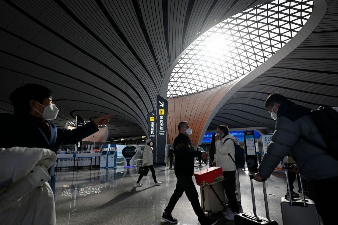 Passengers prepare to check in at Daxing International airport in Beijing on January 19, 2023.