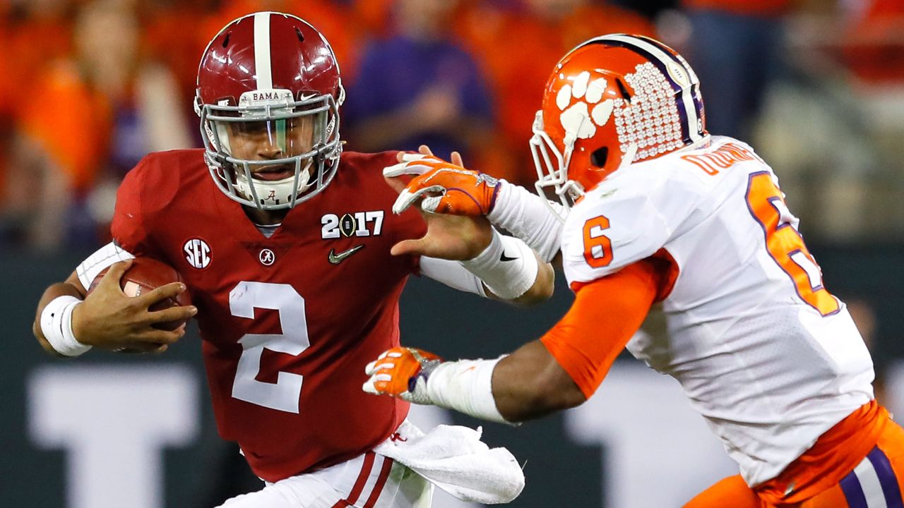 Hurts runs with the ball as linebacker Dorian O'Daniel of the Clemson Tigers attempts to tackle him during the first half of the 2017 College Football Playoff National Championship Game.
