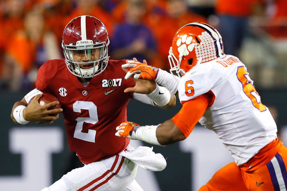 Hurts runs with the ball as linebacker Dorian O'Daniel of the Clemson Tigers attempts to tackle him during the first half of the 2017 College Football Playoff National Championship Game.