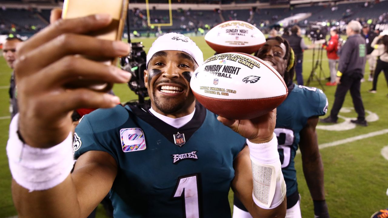 Hurts takes a picture holding the game ball after defeating the Dallas Cowboys 26-17 at Lincoln Financial Field on October 16, 2022.