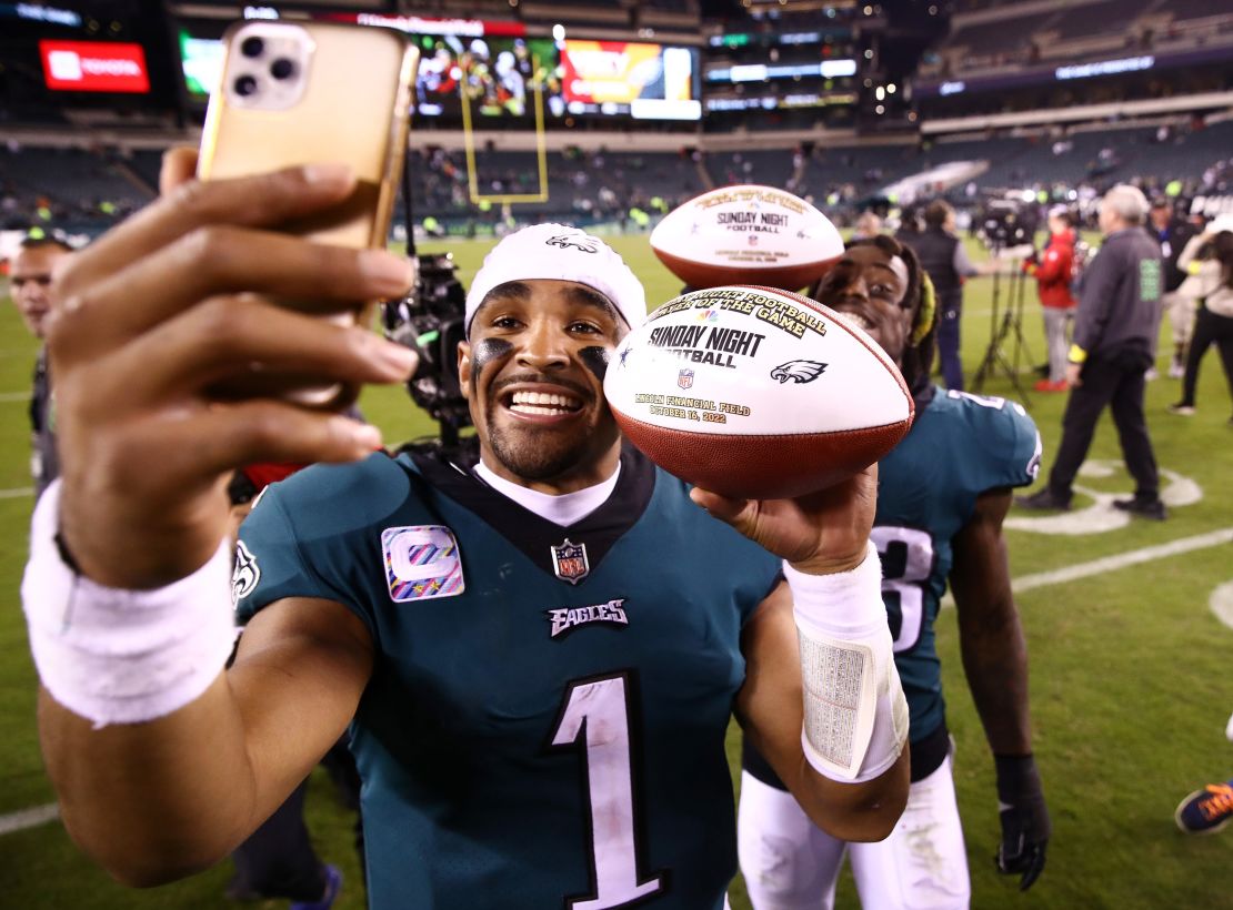 Hurts takes a picture holding the game ball after defeating the Dallas Cowboys 26-17 at Lincoln Financial Field on October 16, 2022.
