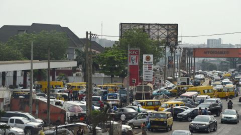 Drivers wait in line to buy fuel at and next to a filling station, causing traffic gridlock on Lagos' Ibadan expressway, in Lagos on January 30, 2023.