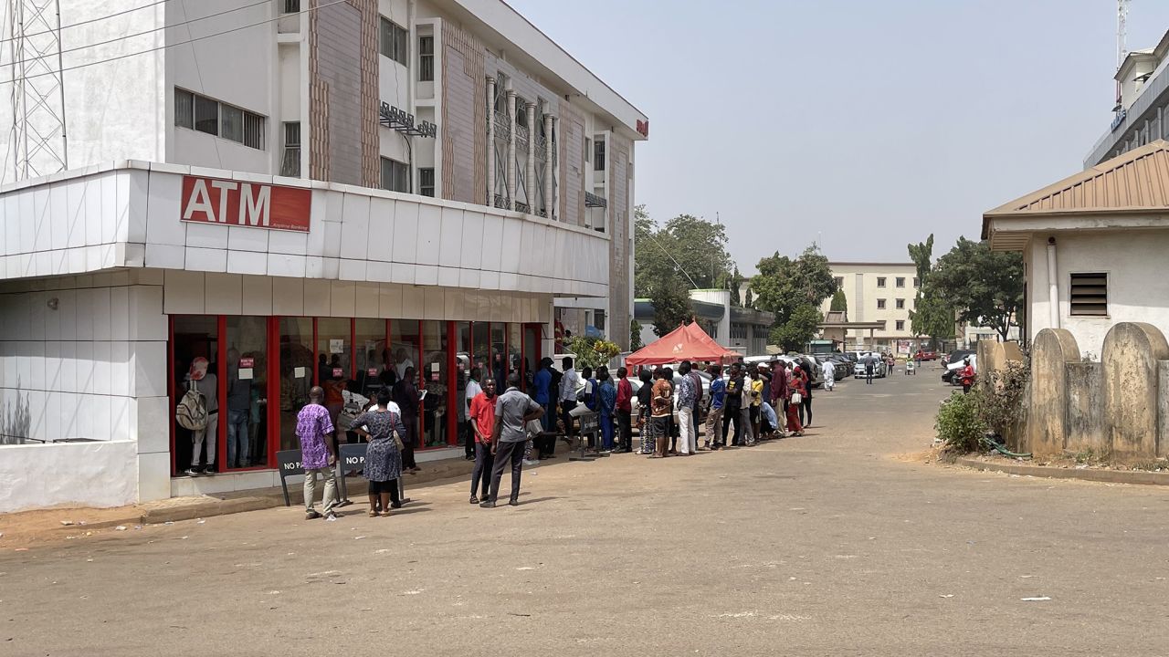 Nigerians queue for new banknotes at an ATM in the capital Abuja, on January 2, 2023.