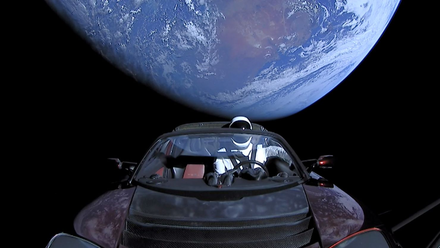 This February 8, 2018 handout photo from SpaceX shows the Tesla roadster after it launched atop a Falcon Heavy rocket with a dummy driver named "Starman." (Photo by SpaceX via Getty Images)
