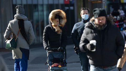 People bundle up in bitterly cold temperatures and high winds in Manhattan as deep cold spread across the Northeast on Friday.