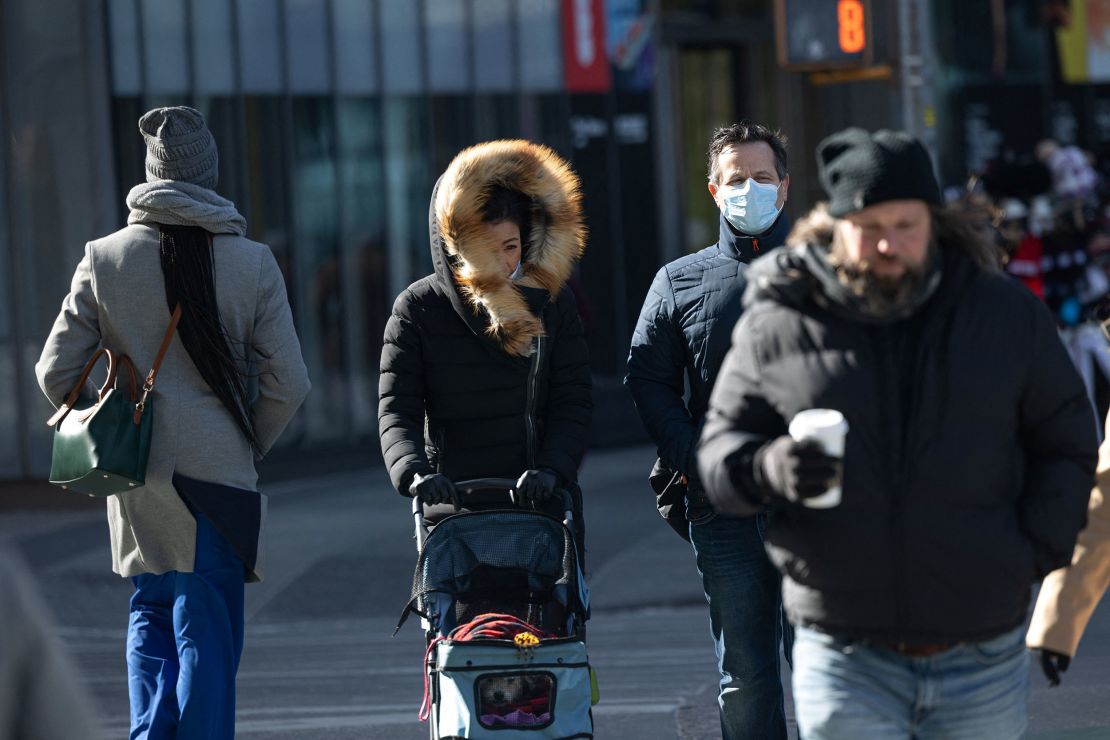 People bundle up in bitterly cold temperatures and high winds in Manhattan as the deep cold spread across the Northeast on Friday.