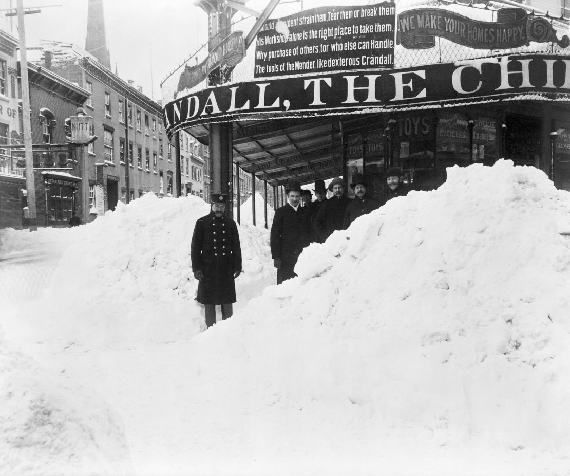 Snow is piled up in front of a New York store during the Blizzard of 1888.
