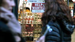 A 'help wanted' sign is displayed in a window of a store in Manhattan on December 02, 2022 in New York City. 