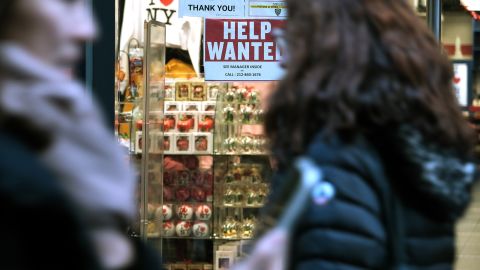A 'help wanted' sign is displayed in a window of a store in Manhattan on December 02, 2022 in New York City.