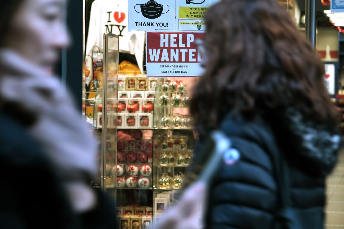 A 'help wanted' sign is displayed in a window of a store in Manhattan on December 02, 2022 in New York City. 