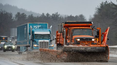 Snow plows trucks clear snow and ice from Interstate highway 93 during a winter storm in Hooksett, New Hampshire.