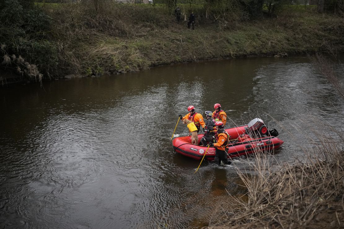 A search dog from Lancashire Police and a crew from Lancashire Fire and Rescue service search the River Wyre for missing woman Nicola Bulley.