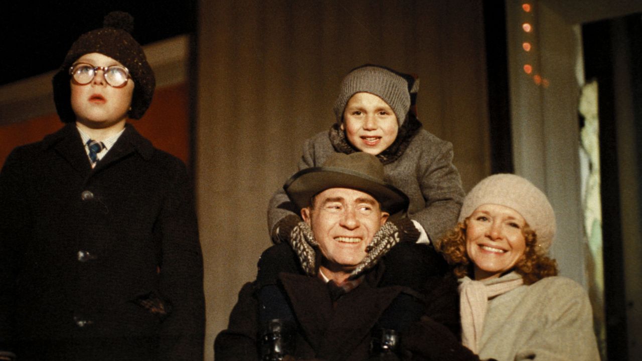 An image of Melinda Dillon, smiling and looking towards the camera, standing next to an actor playing her son in the film 'A Christmas Story.