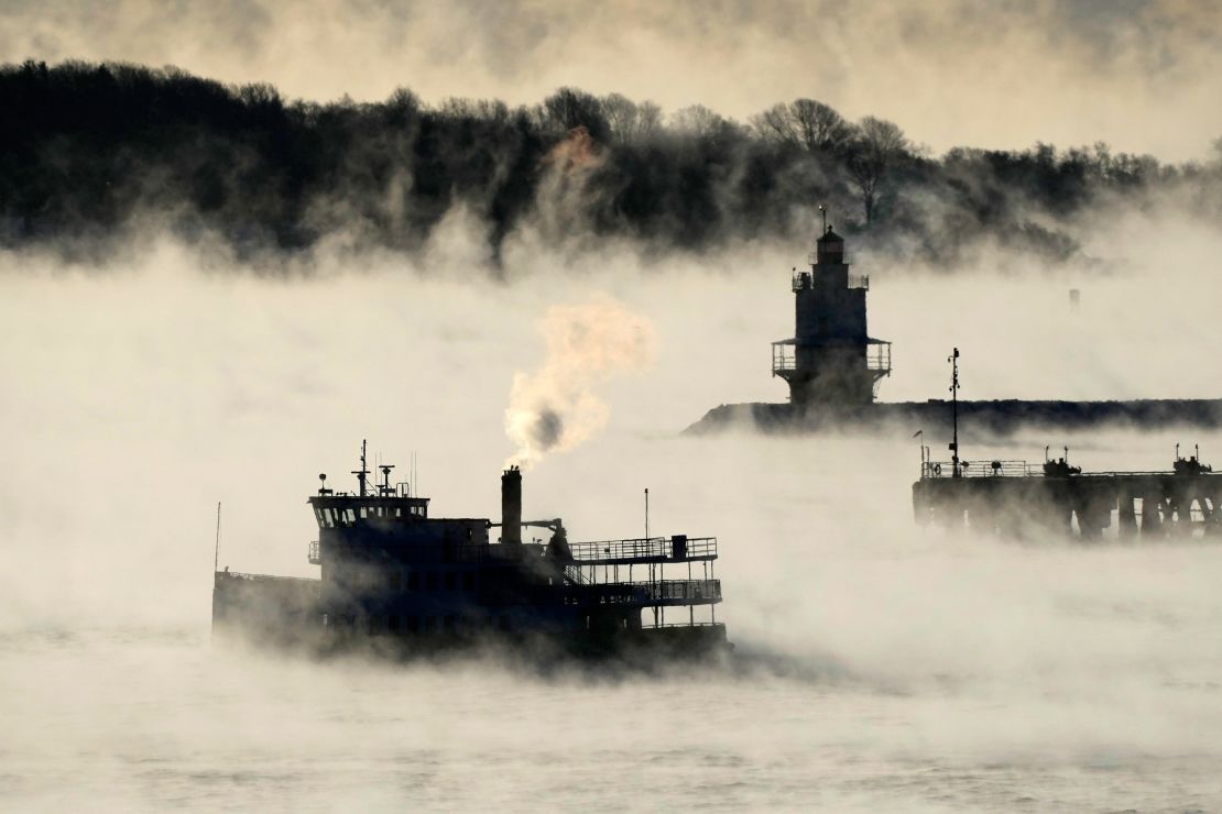 Arctic sea smoke rises from the the Atlantic Ocean as a passenger ferry passes Spring Point Ledge Light, Saturday, Feb. 4, 2023, off the coast of South Portland, Maine. The morning temperature was about -10 degrees Fahrenheit. 