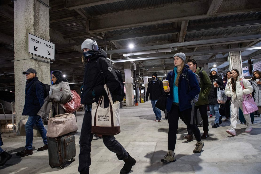 Bundled-up commuters make their way to board a Northeast Regional Amtrak train as temperatures reach minus 7 in Boston, Massachusetts, on February 4, 2023. 