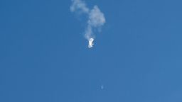 A jet flies by a suspected Chinese spy balloon after shooting it down off the coast in Surfside Beach, South Carolina, U.S. February 4, 2023.  REUTERS/Randall Hill