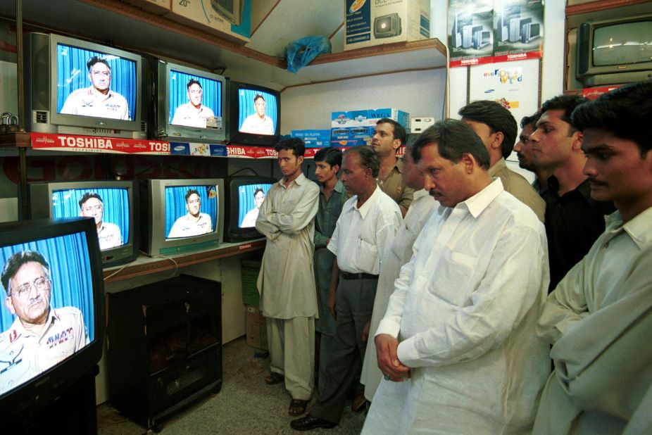 People in Karachi, Pakistan, watch Musharraf address the nation in September 2001. Musharraf said the United States was in the grip of "grief, anger and vengeance" following the 9/11 terrorist attacks.