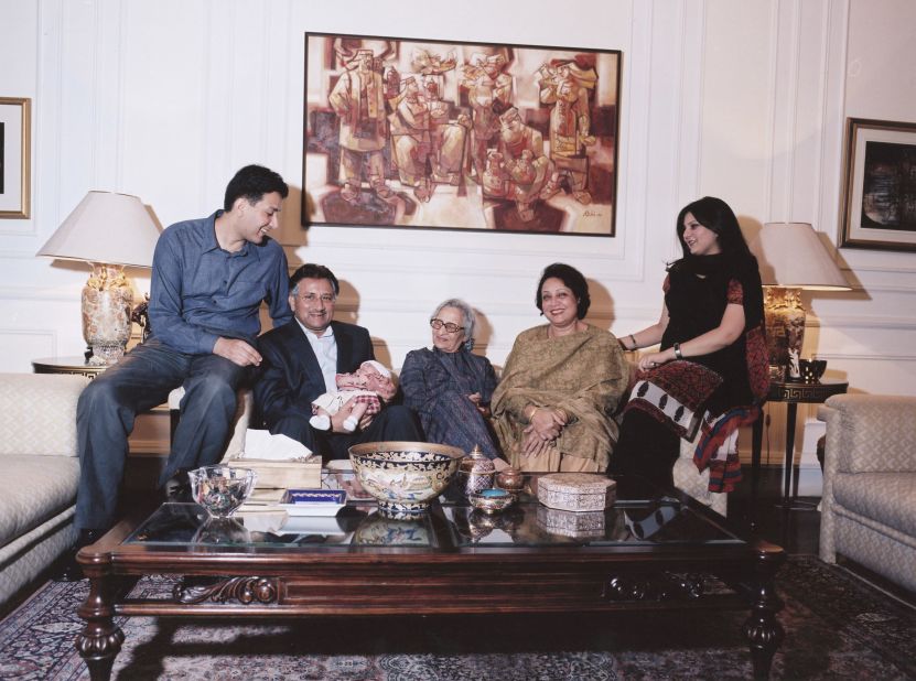 Musharraf holds his grandchild Hamza as he is joined by members of his family in Islamabad in January 2003. Musharraf and his wife, Sehba, had two children, Bilal and Ayla. At center is his mother, Zarin.