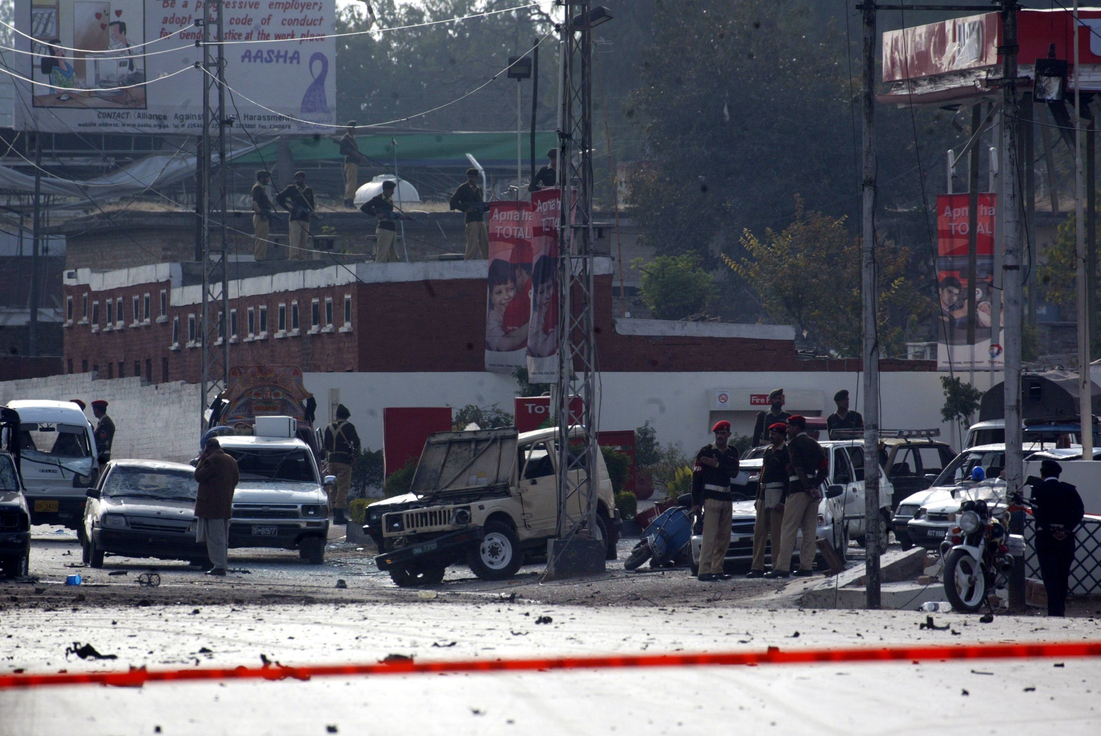 Pakistani soldiers stand guard in Rawalpindi after there were suicide bomb blasts on Musharraf's motorcade in December 2003.