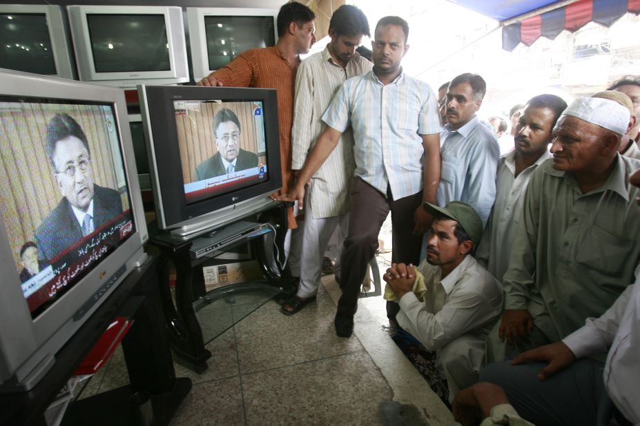People in Lahore watch Musharraf's resignation speech on August 18, 2008. Musharraf announced his resignation in the face of an impending impeachment motion by the ruling coalition government.